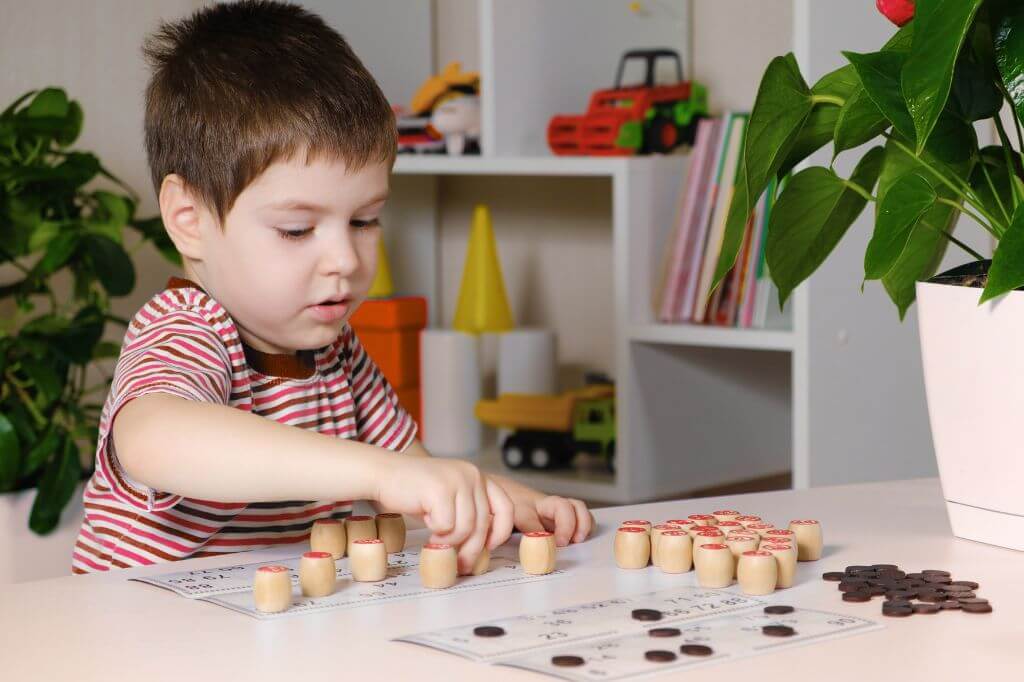 5 year old boy playing at a table