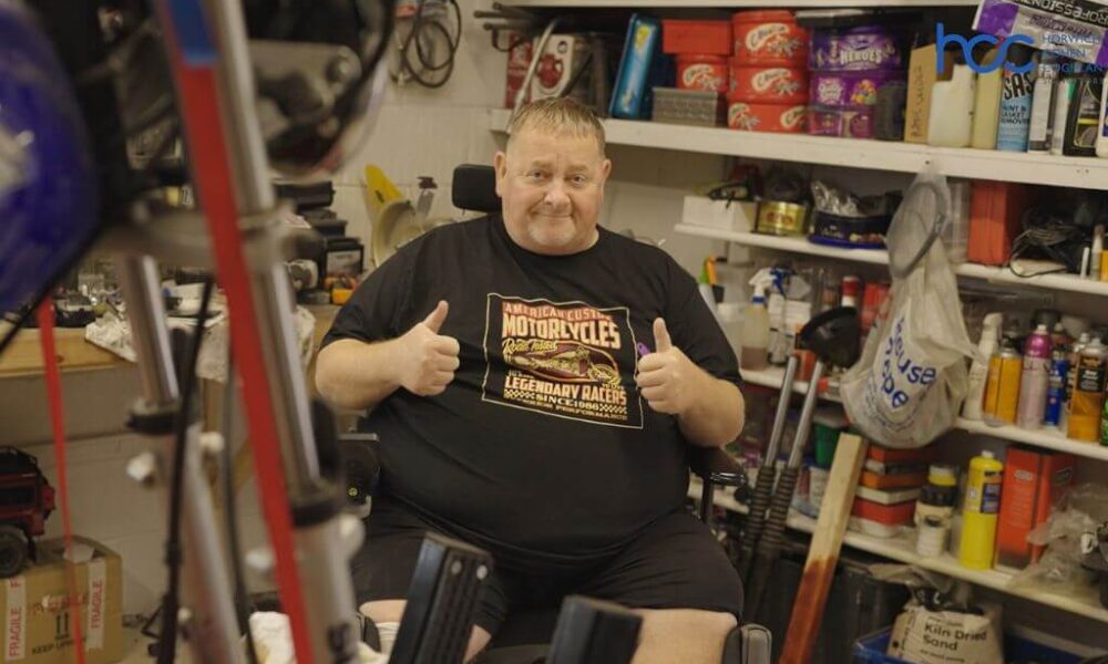 Chris in his wheelchair in his garage and his motorcycles